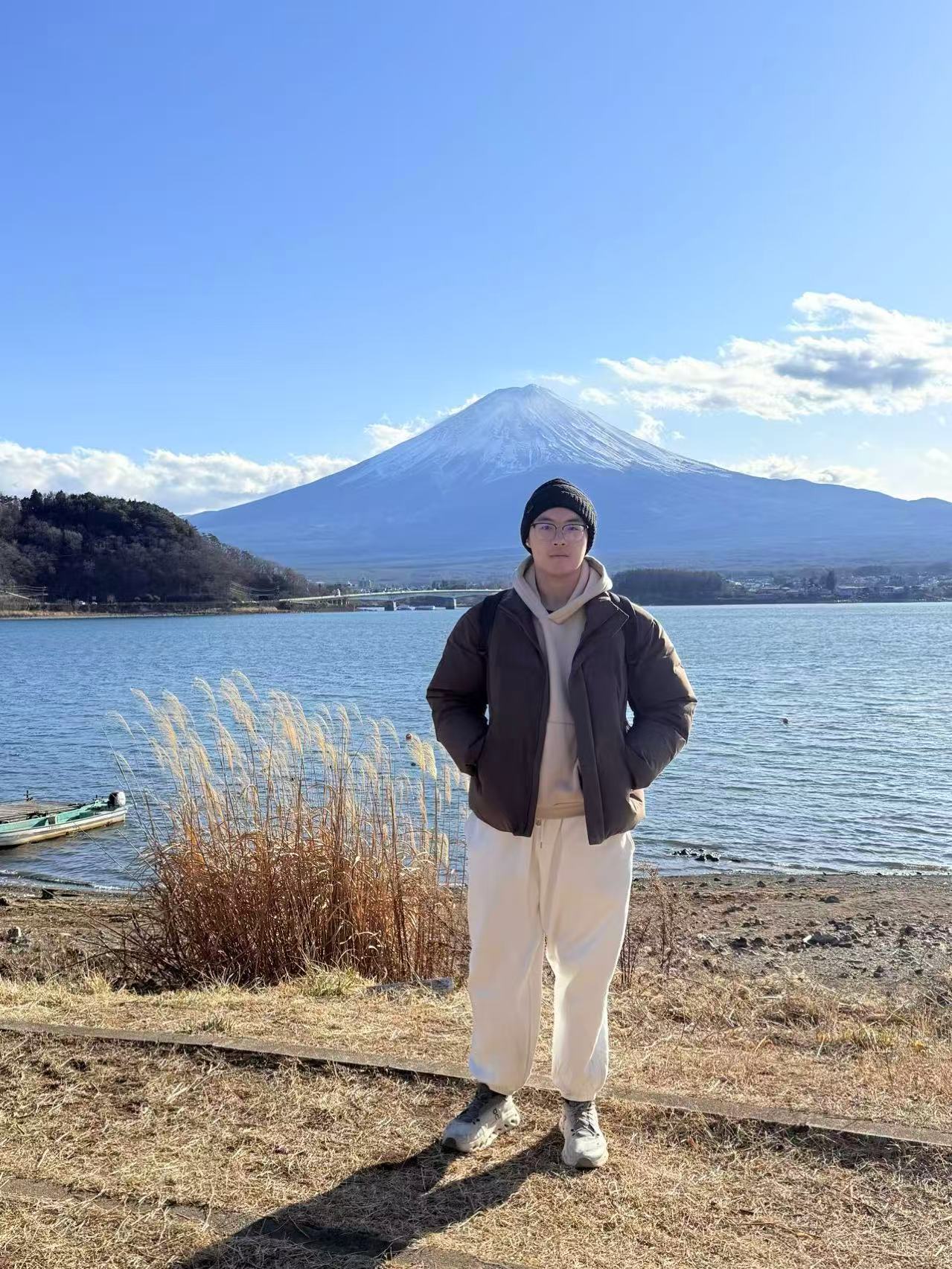Jiahao Liu by a lake with Mount Fuji in the background.
